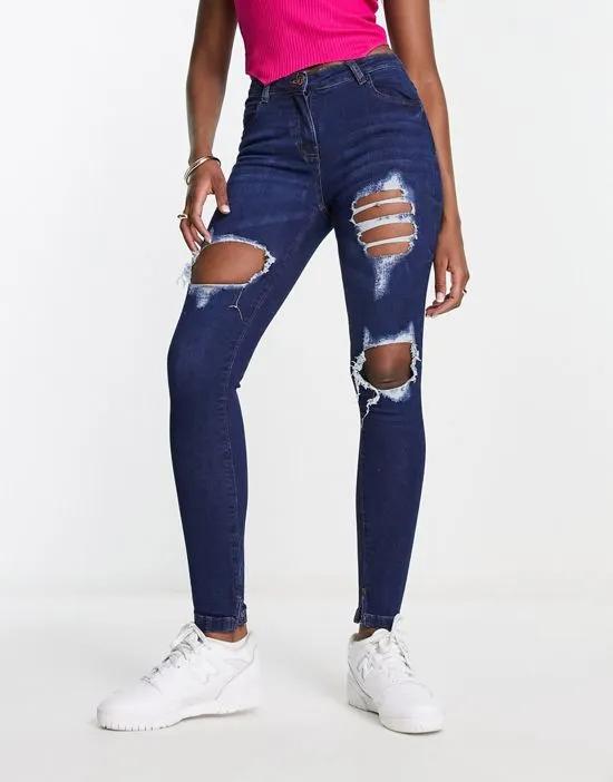 distressed skinny jeans in indigo