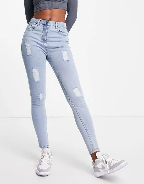 distressed skinny jeans in light blue