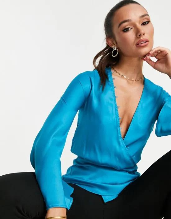 drape long sleeve top with and peplum hem in bright teal