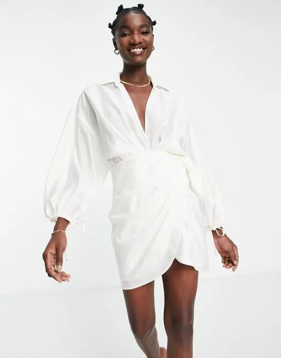 drape wrap front mini dress with oversize blouson sleeve and open back detail