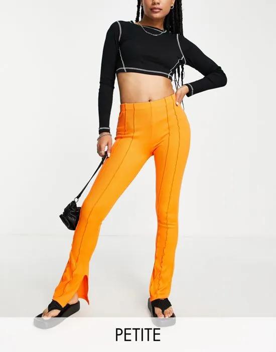 exposed seam skinny flare pants in orange