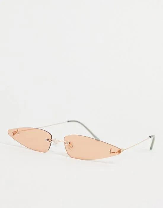extreme cat eye sunglasses with silver frames and pale orange lens