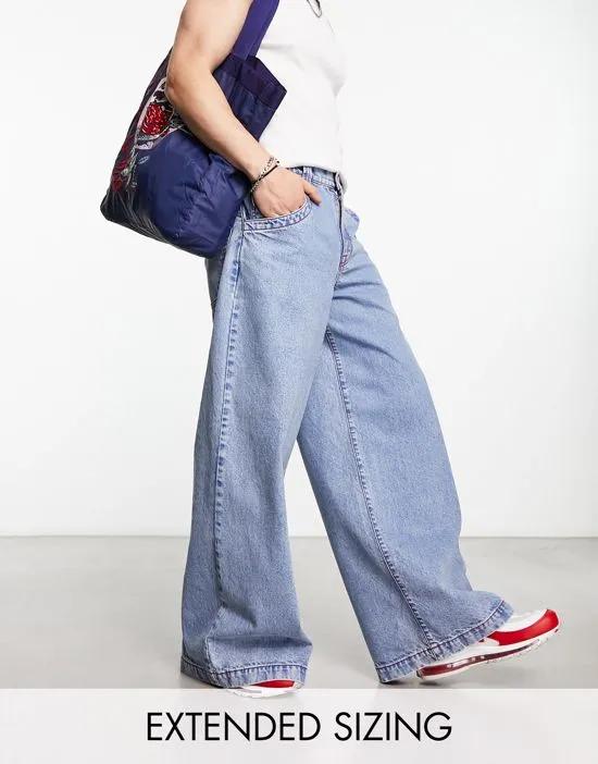 extreme wide leg jeans with red contrast stitch in blue wash