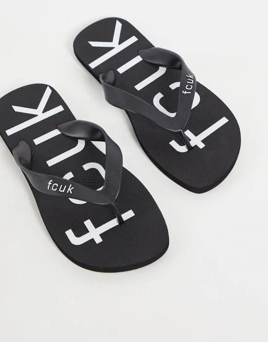 FCUK logo flip flops in black and white