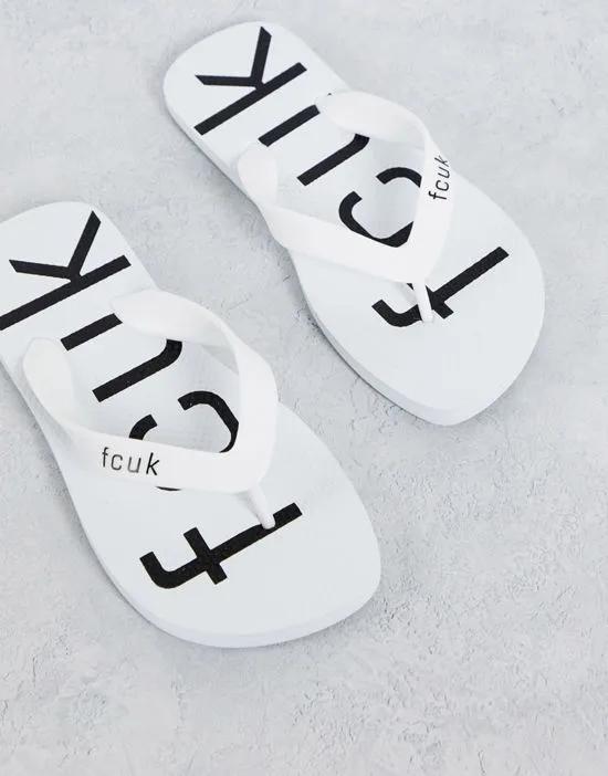 FCUK logo flip flops in white and black