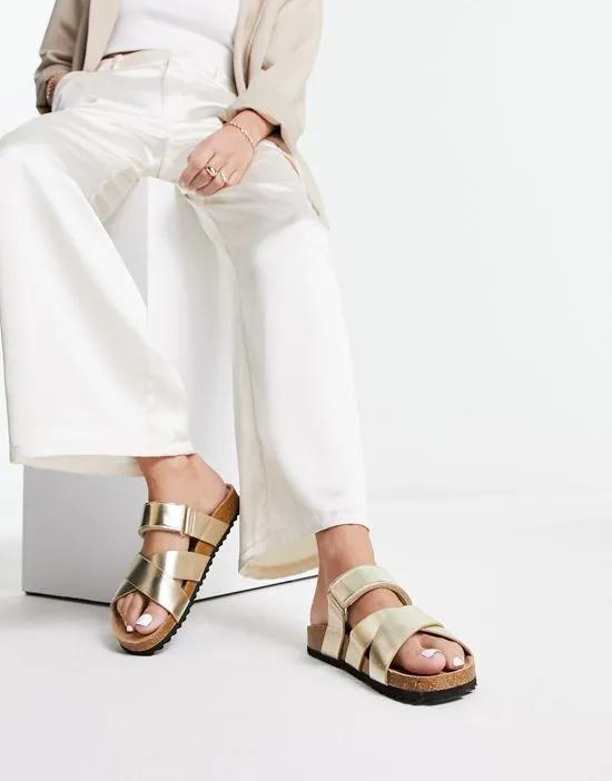Fiery cross strap flat sandals in gold