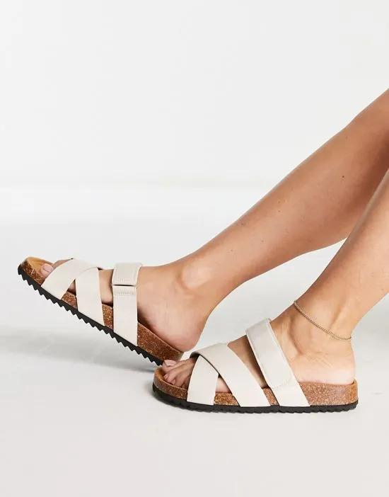 Fiery cross strap flat sandals in off white