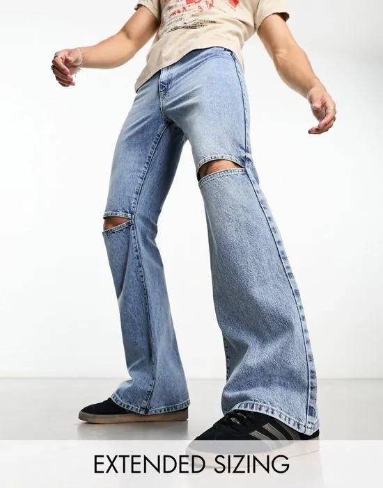 flare jeans with open knees in mid wash blue
