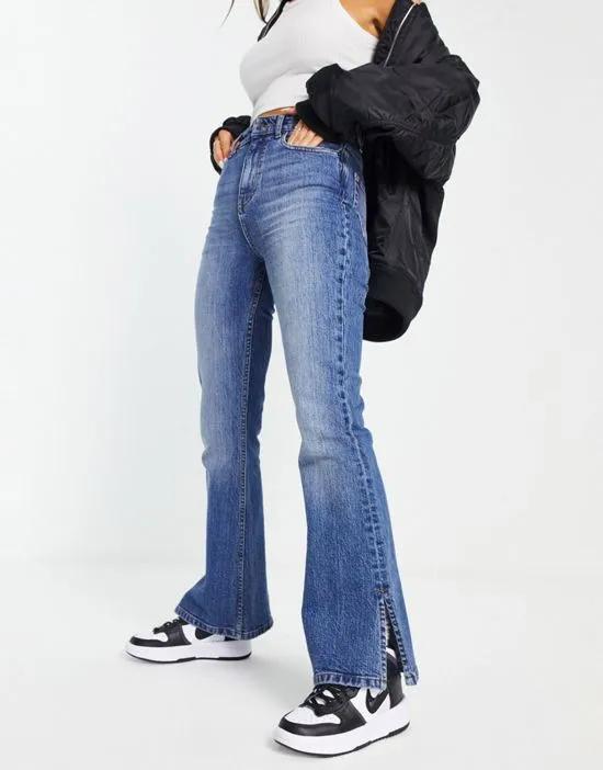 flared jeans in dark blue with split hem