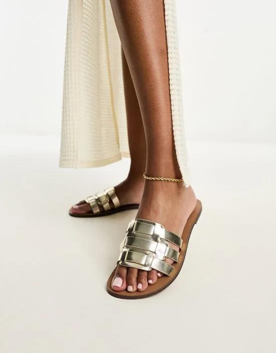 flat sandals in gold