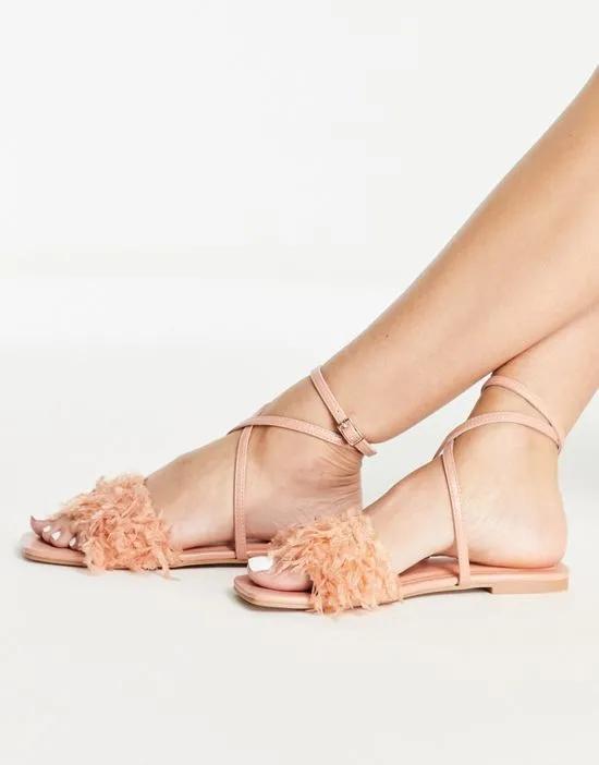 Four faux feather flat sandals in pink