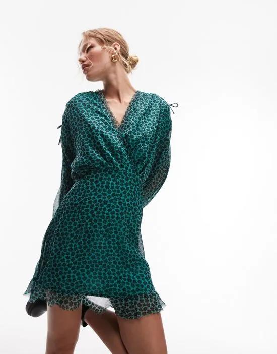 frill neck mini tea dress with raw seams in green and black floral