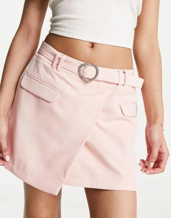 heart diamante buckle asym mini skirt in pale pink