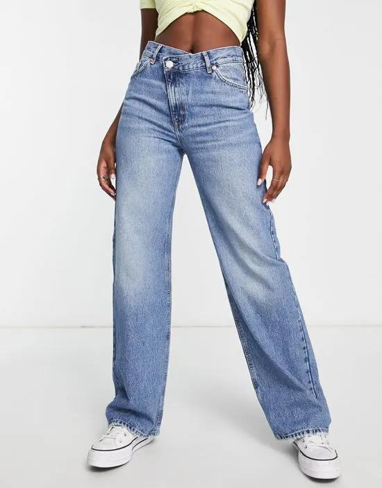 high rise jeans with cross over waist in light blue