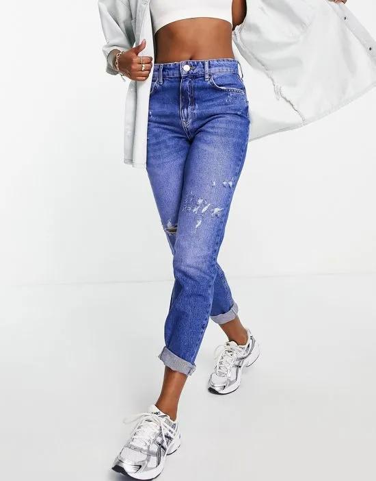high rise mom jeans with rips in bright blue