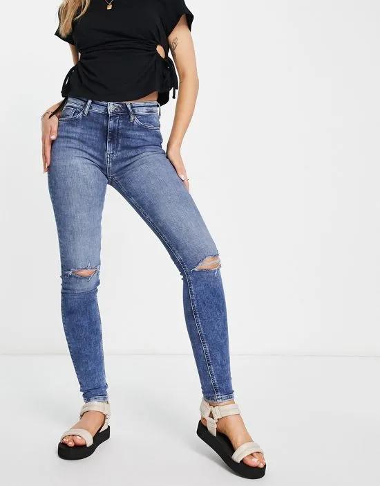 high rise skinny jeans with distressed knees in medium wash