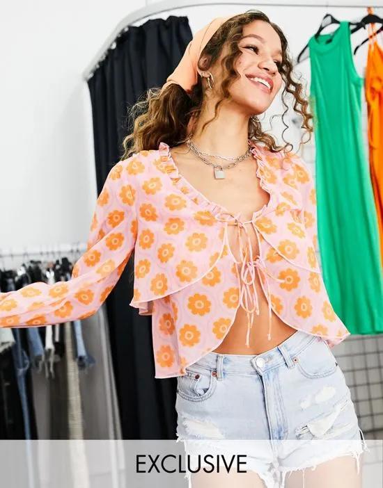 Inspired crinkle tie front ruffle blouse in orange floral print
