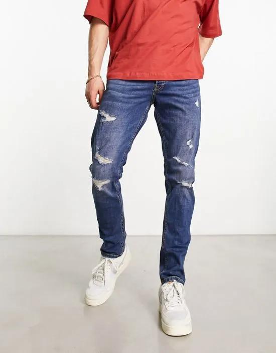 Intelligence glenn slim fit jean in mid blue wash with abrasions