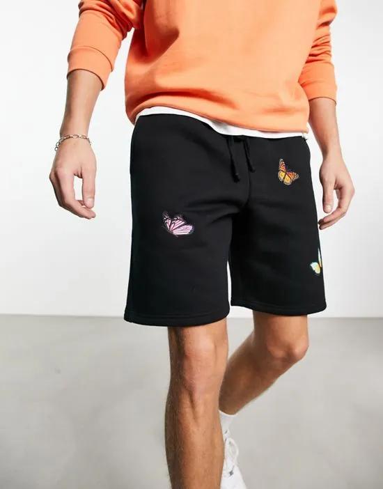jersey shorts in black with butterfly placement prints