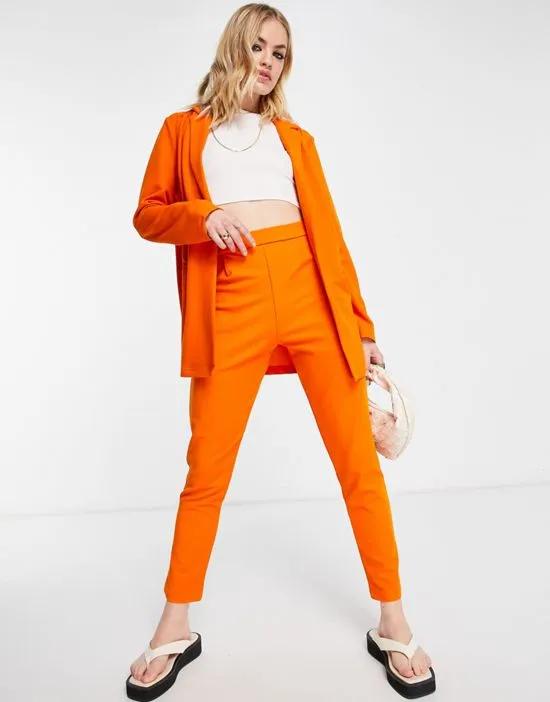 jersey tapered suit pants in orange