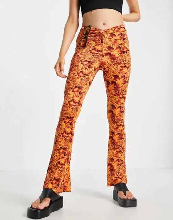 knot twist front flared pants in hibiscus print