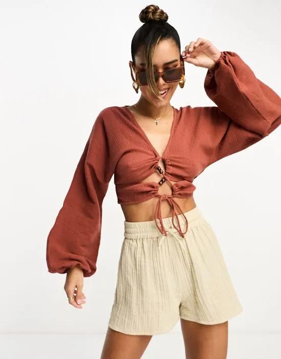 long sleeve crinkle top with lace up lattice detail in rust