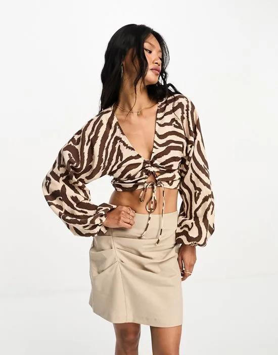 long sleeve crinkle top with lace up lattice detail in zebra print