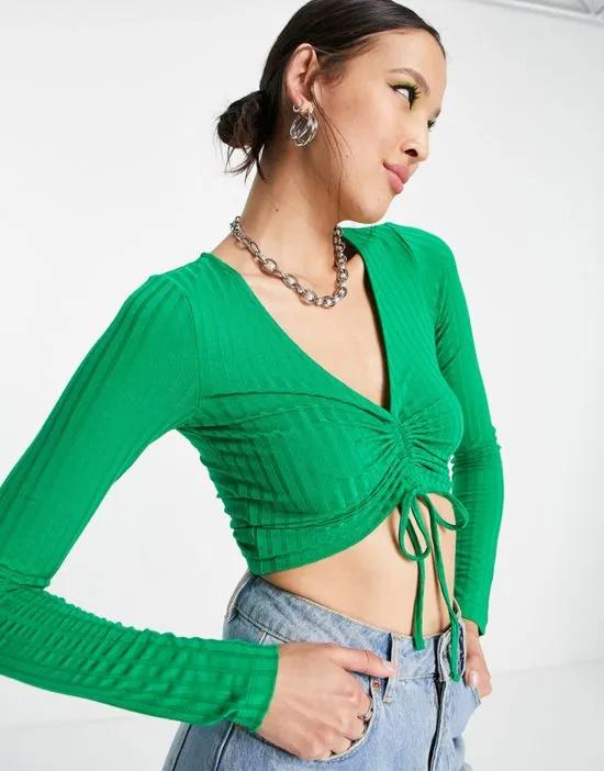 long sleeve crop top with ruched front in bold green