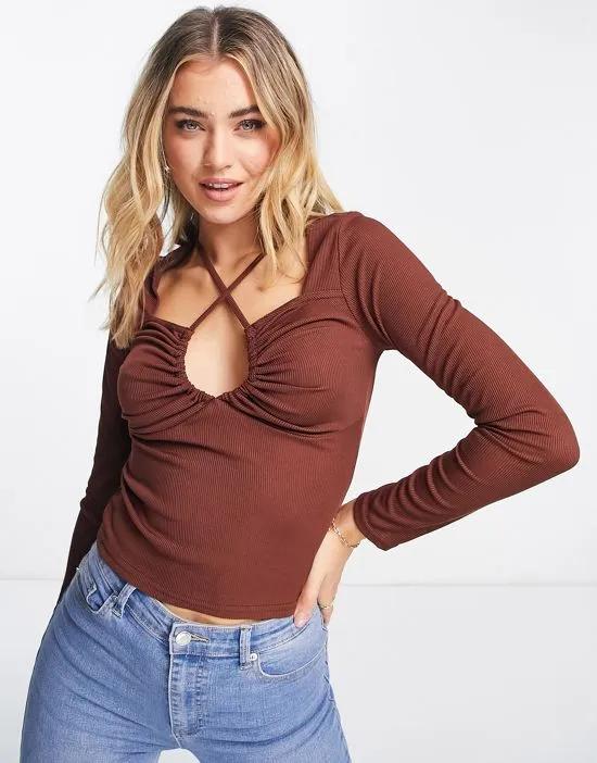 long sleeve keyhole cut out top in brown
