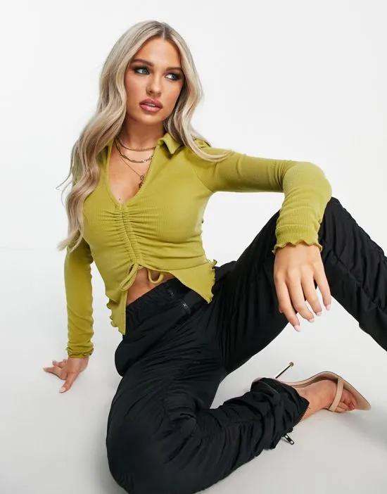 long sleeve ruched front butterfly hem top in olive