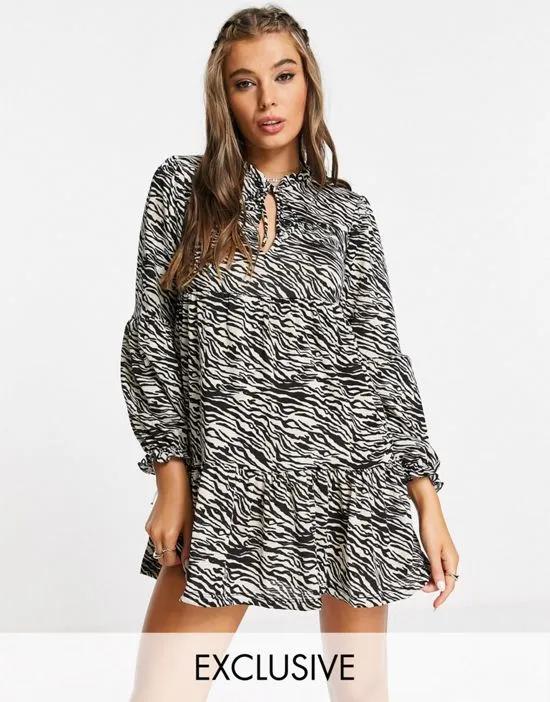 long sleeve smock dress with tie neck in animal print