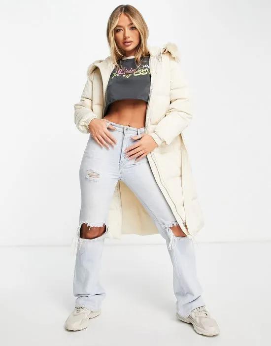 longline belted puffer coat with faux fur hood in cream