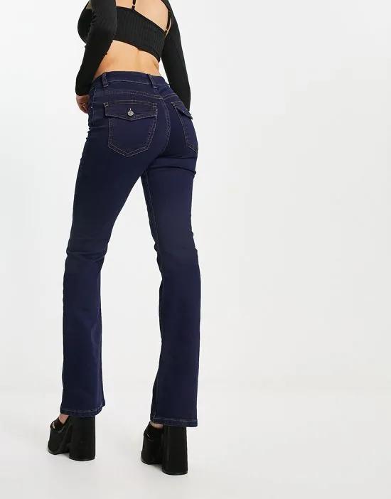 low rise flared jeans with western pocket detail in dark blue