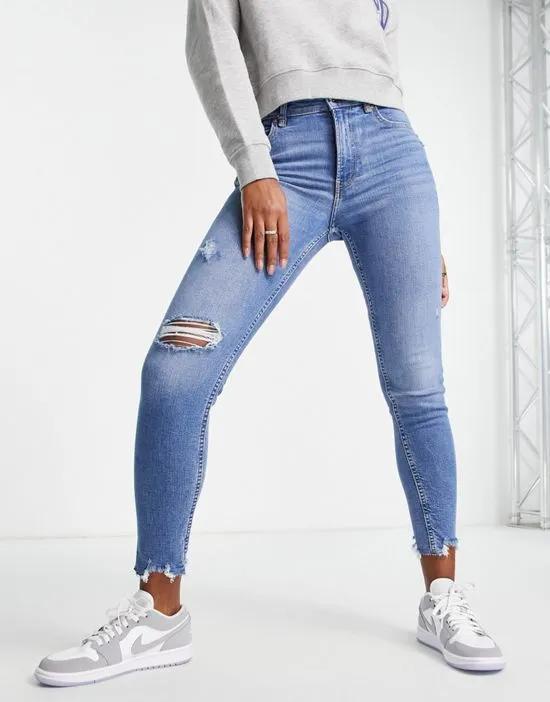 low waist skinny jean with rips in medium blue