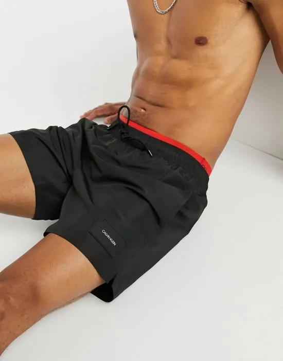 medium length swim shorts with double waistband in black