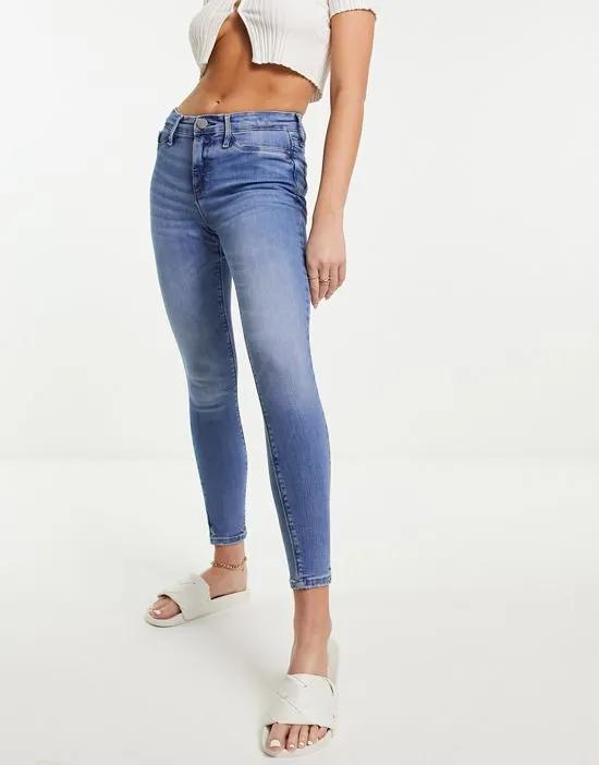 mid rise washed skinny jeans in mid blue