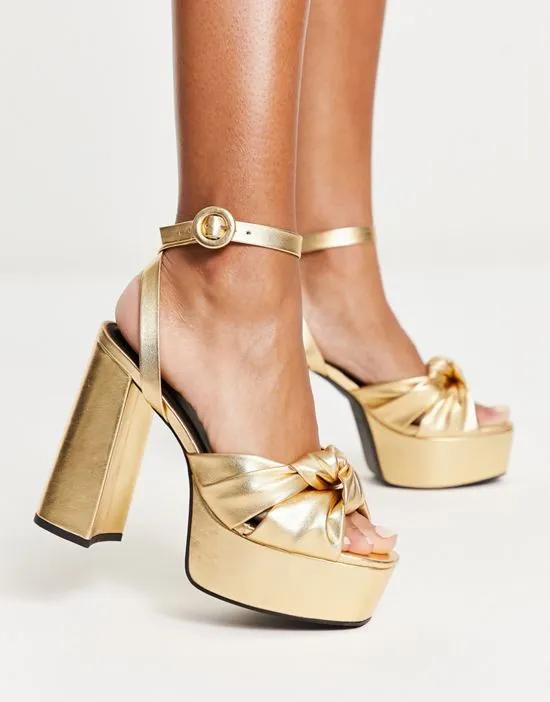 Natia knotted platform heeled sandals in gold