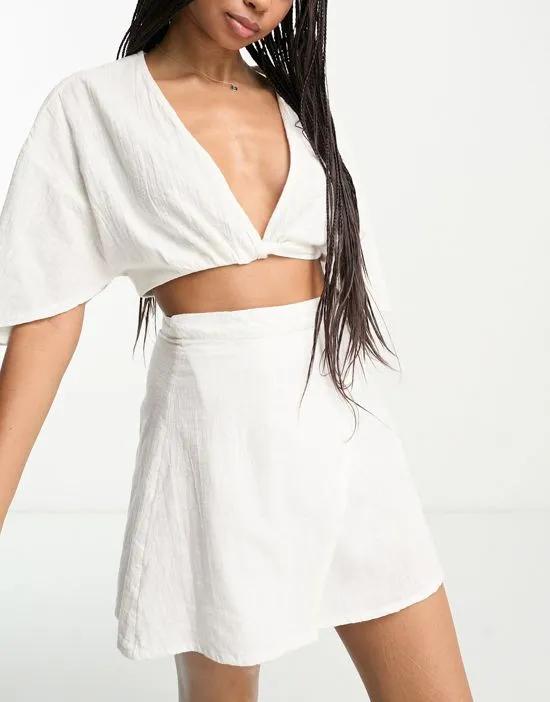 natural beach wrap front mini skirt in white - part of a set
