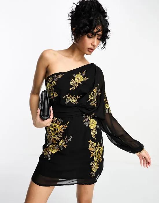 one shoulder chiffon mini dress in black with marigold floral artwork