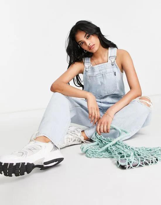 overalls with ripped knees in light blue wash