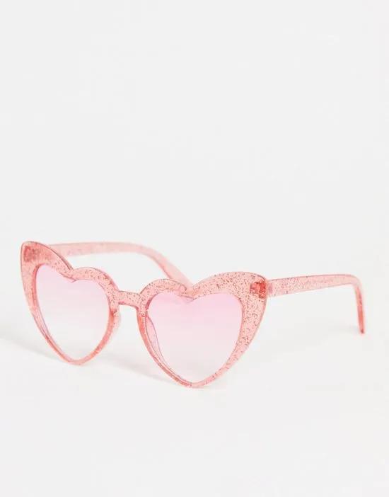 oversized heart sunglasses in pink glitter with pink tinted lens