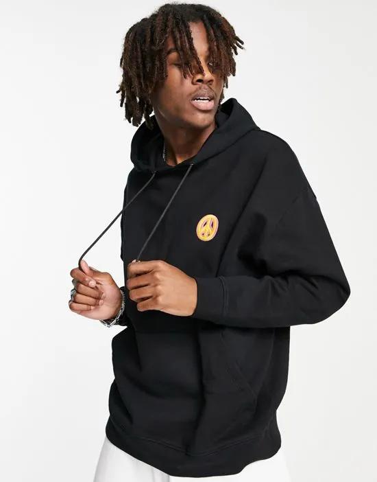 oversized hoodie in black with small symbol embroidery - part of a set