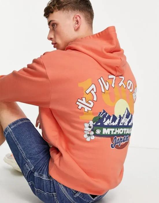 oversized hoodie in orange with mountain back print
