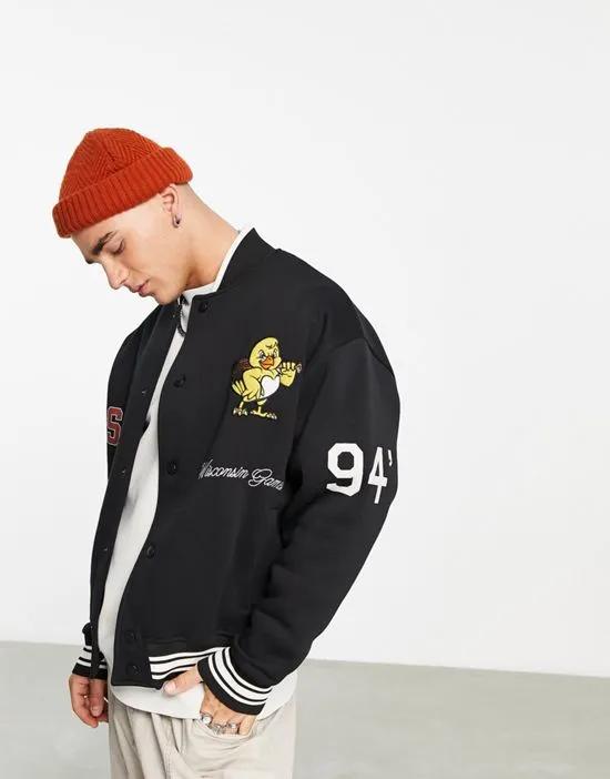 oversized jersey track jacket in black with collegiate badging