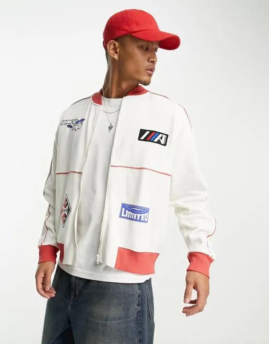 oversized jersey track jacket in off white with sports patches
