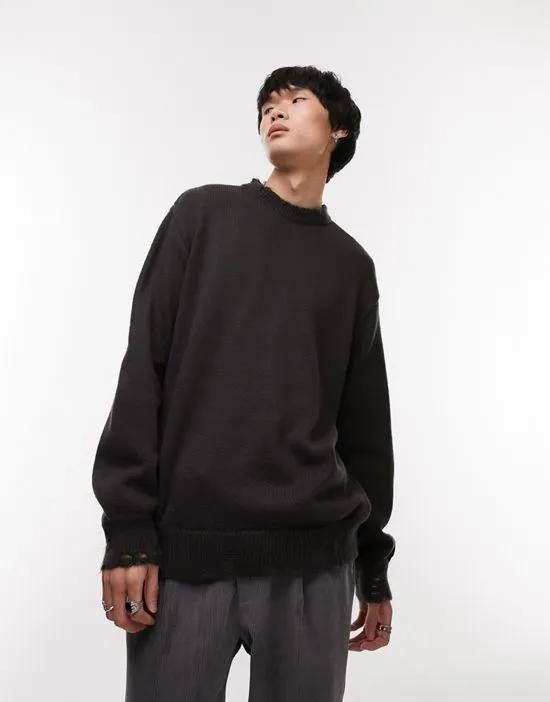 oversized knit crew neck sweater with distressing in washed black