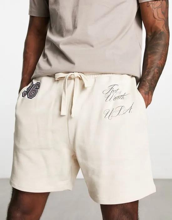 oversized shorts in beige with text print