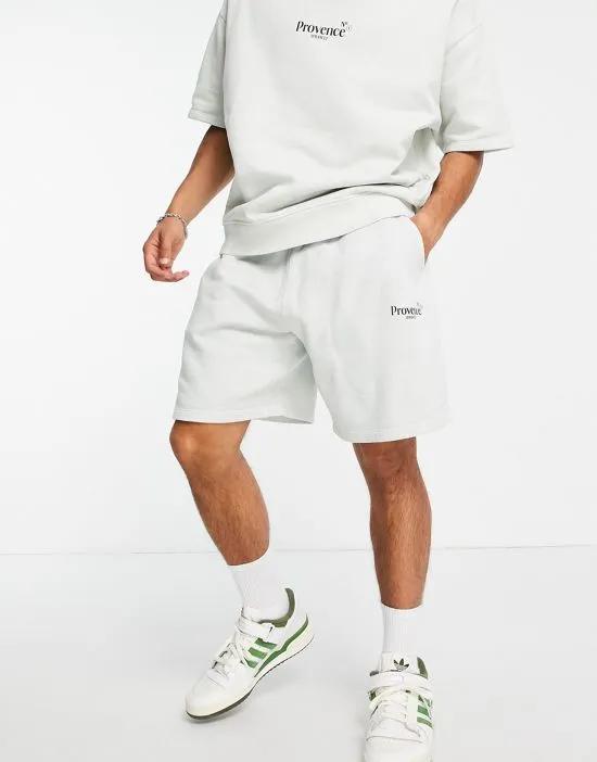 oversized shorts in washed white cotton with city print - WHITE