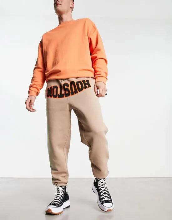 oversized sweatpants with collegiate text print