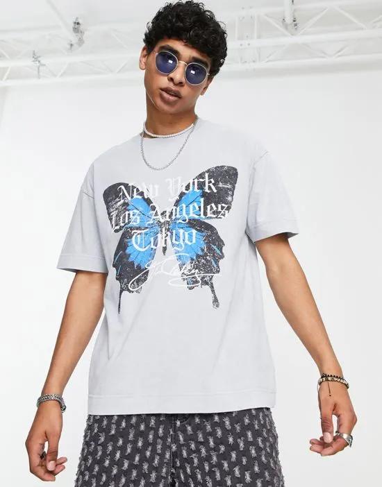 oversized t-shirt in light gray acid wash with city and butterfly print